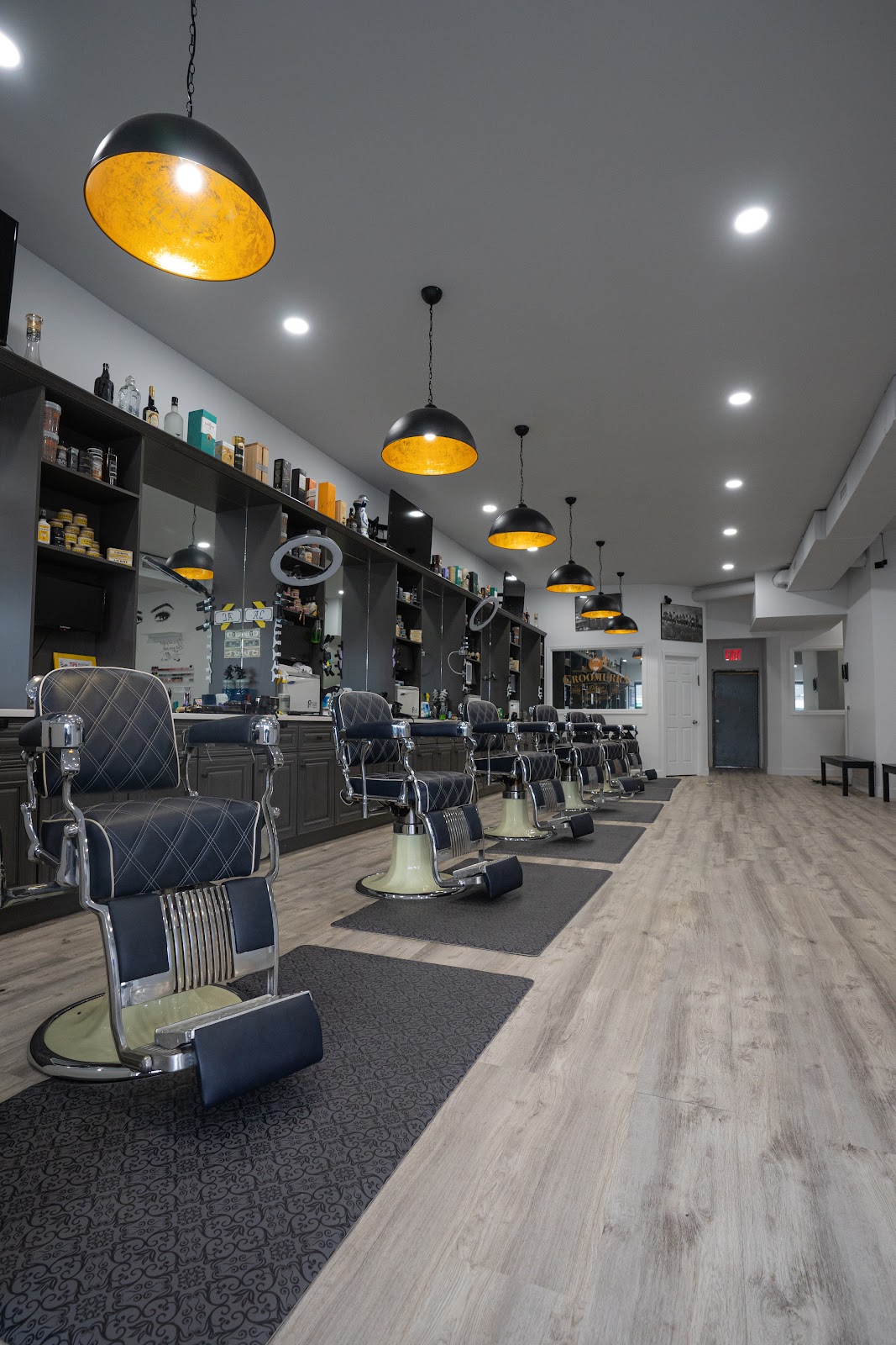 Barber chairs under gold pendant lights